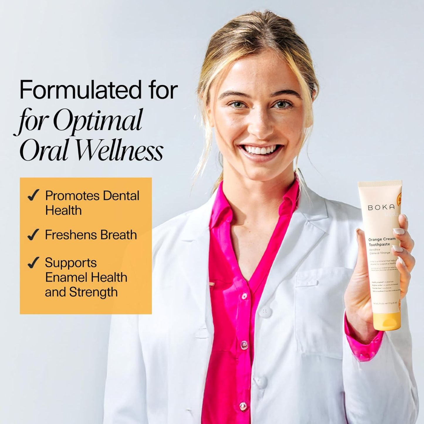 Woman in a white coat holds Orange Cream n-Ha Toothpaste; text highlights fresh breath and strong enamel.