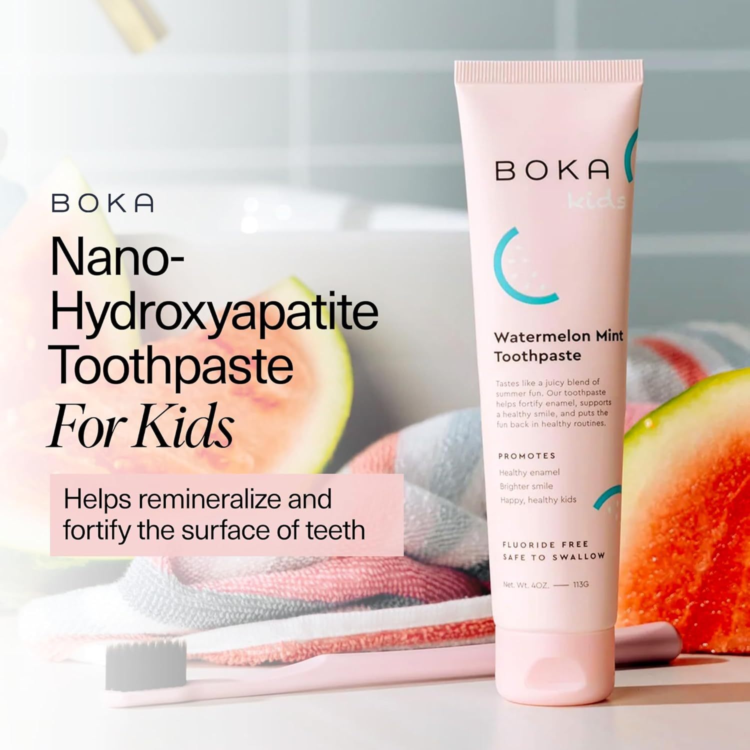 Watermelon Mint n-Ha Toothpaste, fluoride-free, in pink tube beside a toothbrush and watermelon slices.