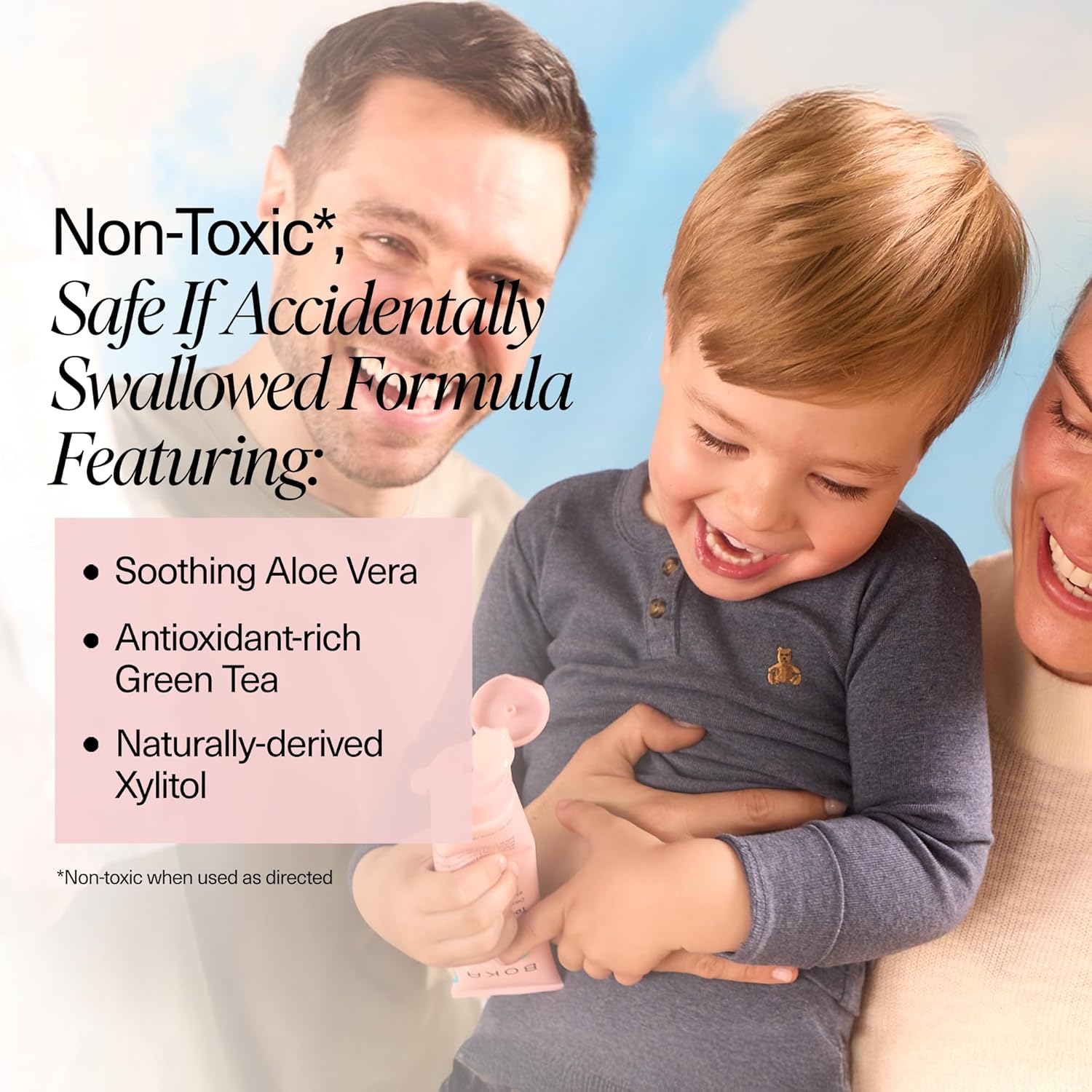 Smiling family with toddler holding Watermelon Mint n-Ha Toothpaste, safe and fluoride-free.