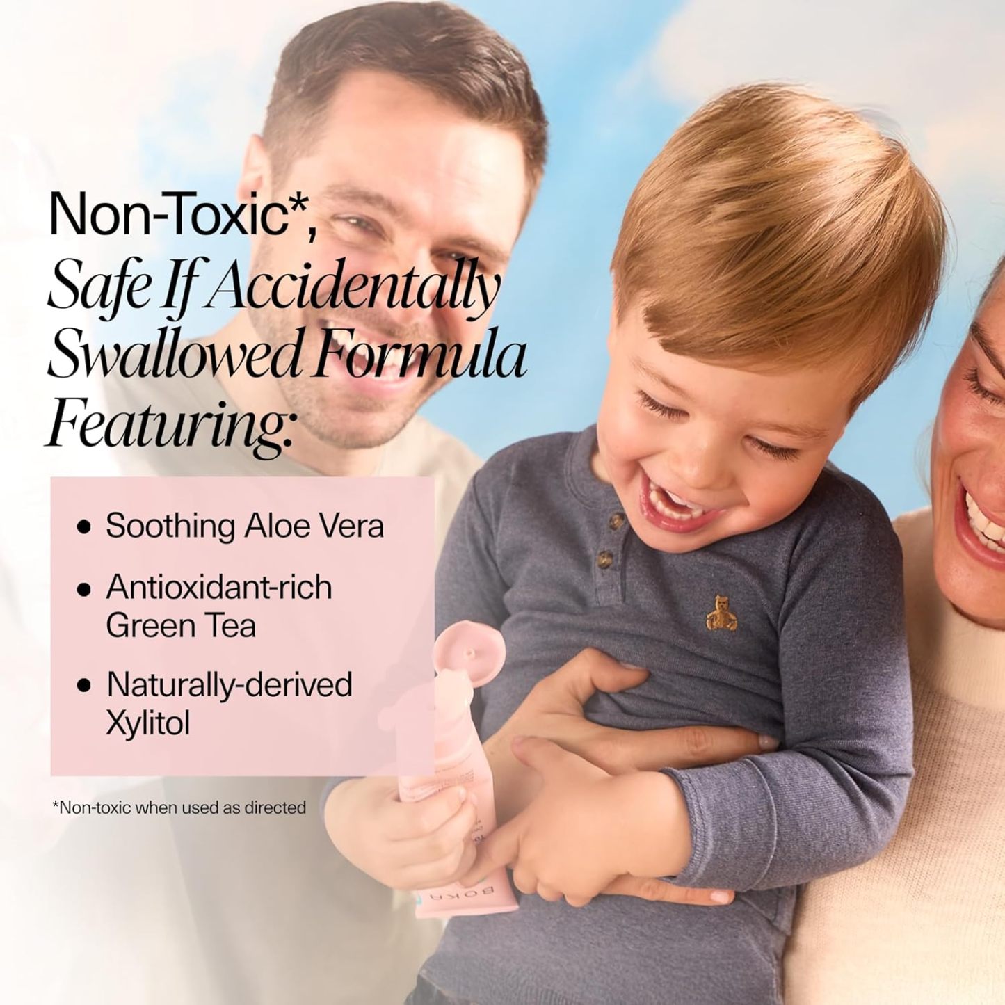 Smiling family with toddler holding Watermelon Mint n-Ha Toothpaste, safe and fluoride-free.
