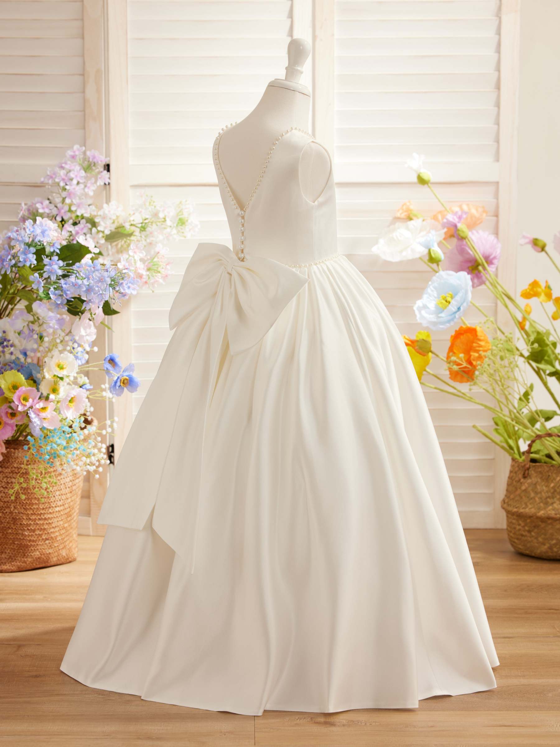 Satin dress with beaded neckline and bow detail in pink sleeveless