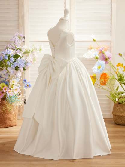 Satin dress with beaded neckline and bow detail in pink sleeveless