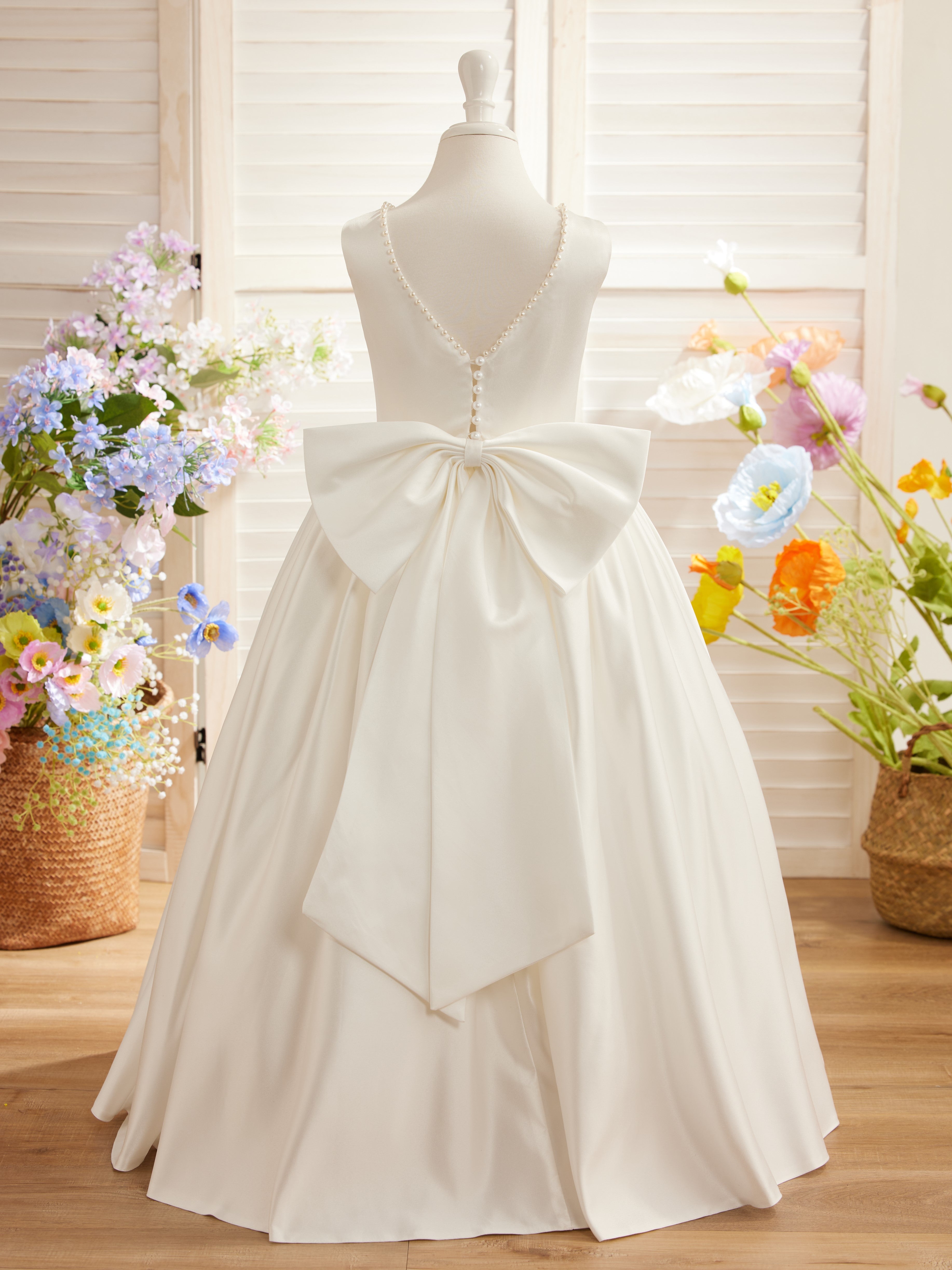 Satin dress with beaded neckline and bow detail in pink sleeveless