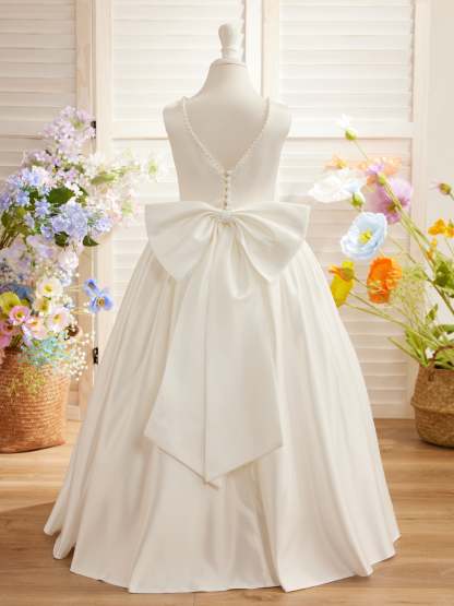 Satin dress with beaded neckline and bow detail in pink sleeveless