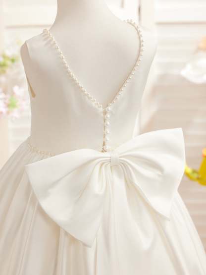 Satin dress with beaded neckline and bow detail in pink sleeveless