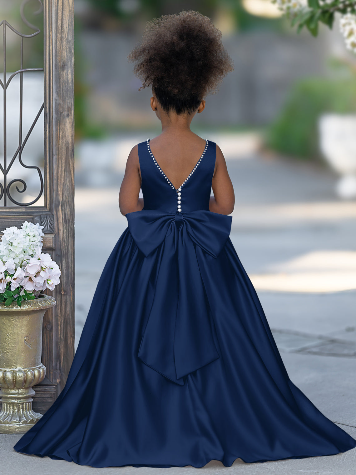 Satin dress with beaded neckline and bow detail in pink sleeveless