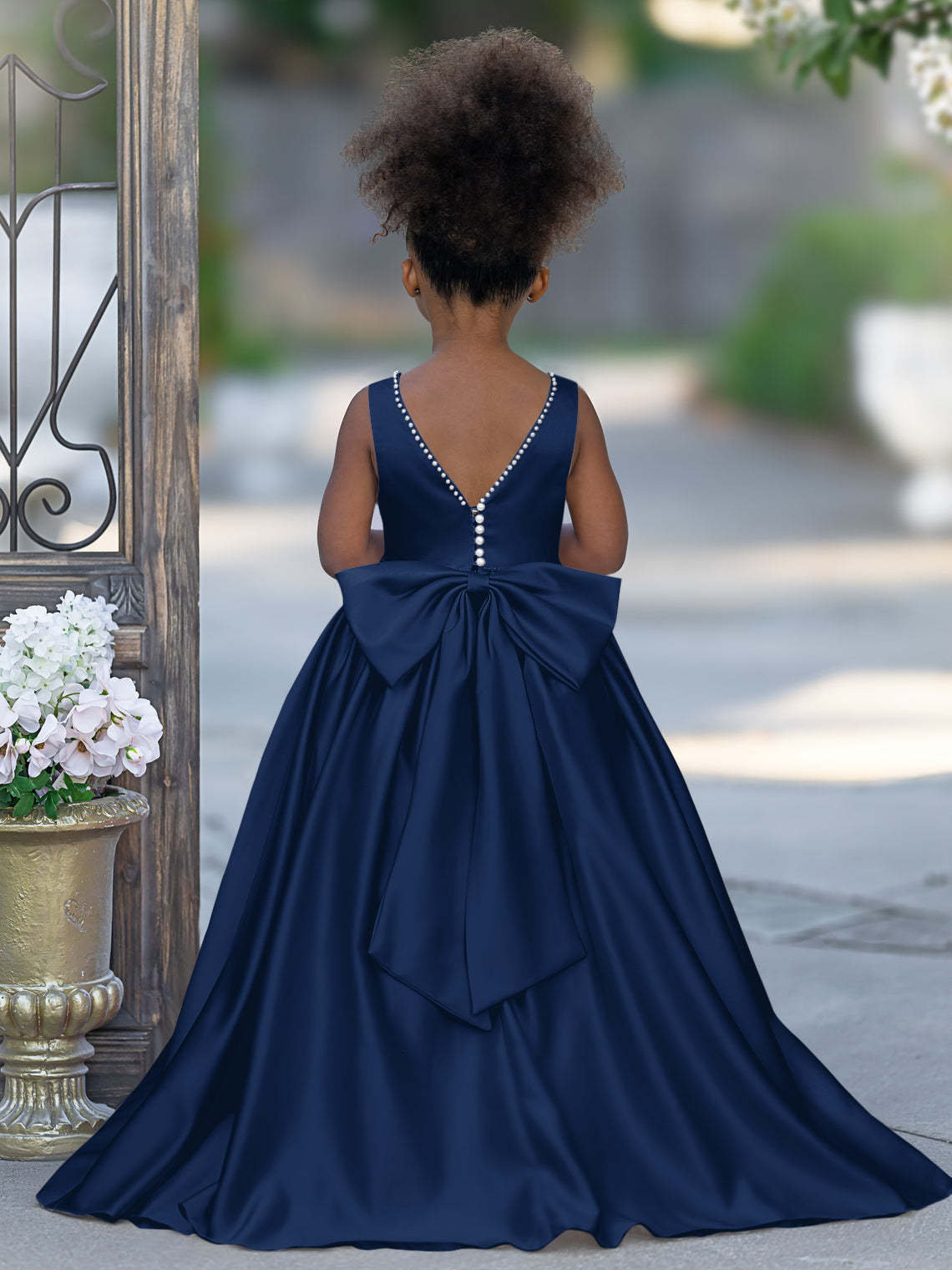 Satin dress with beaded neckline and bow detail in pink sleeveless