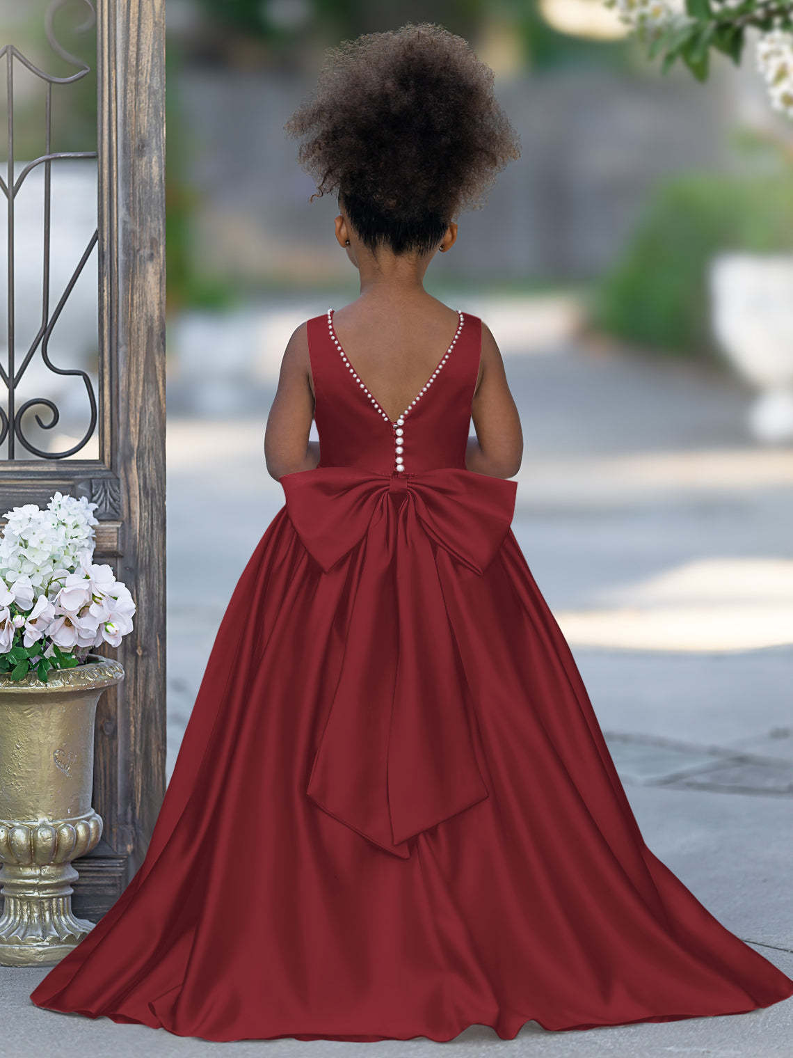 Satin dress with beaded neckline and bow detail in pink sleeveless