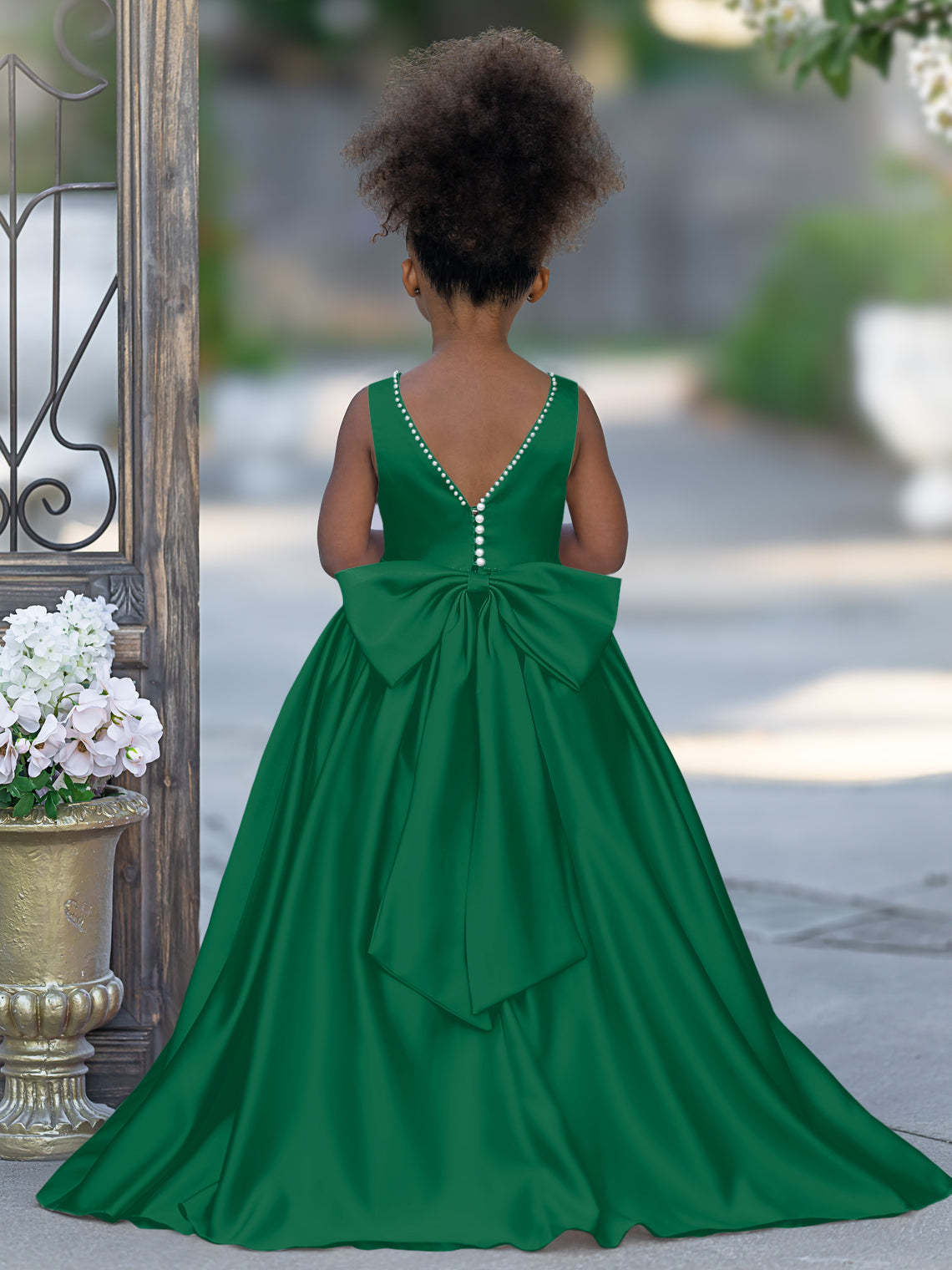 Satin dress with beaded neckline and bow detail in pink sleeveless