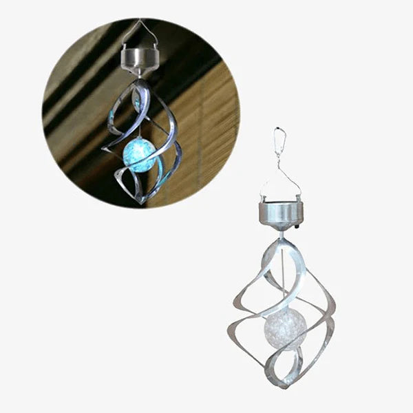 Decorative solar-powered hanging light with a spiral metal frame encasing a crackled glass globe. The main image shows the light unlit in daylight, while an inset shows it glowing with a soft blue light at night, highlighting its color-changing feature.