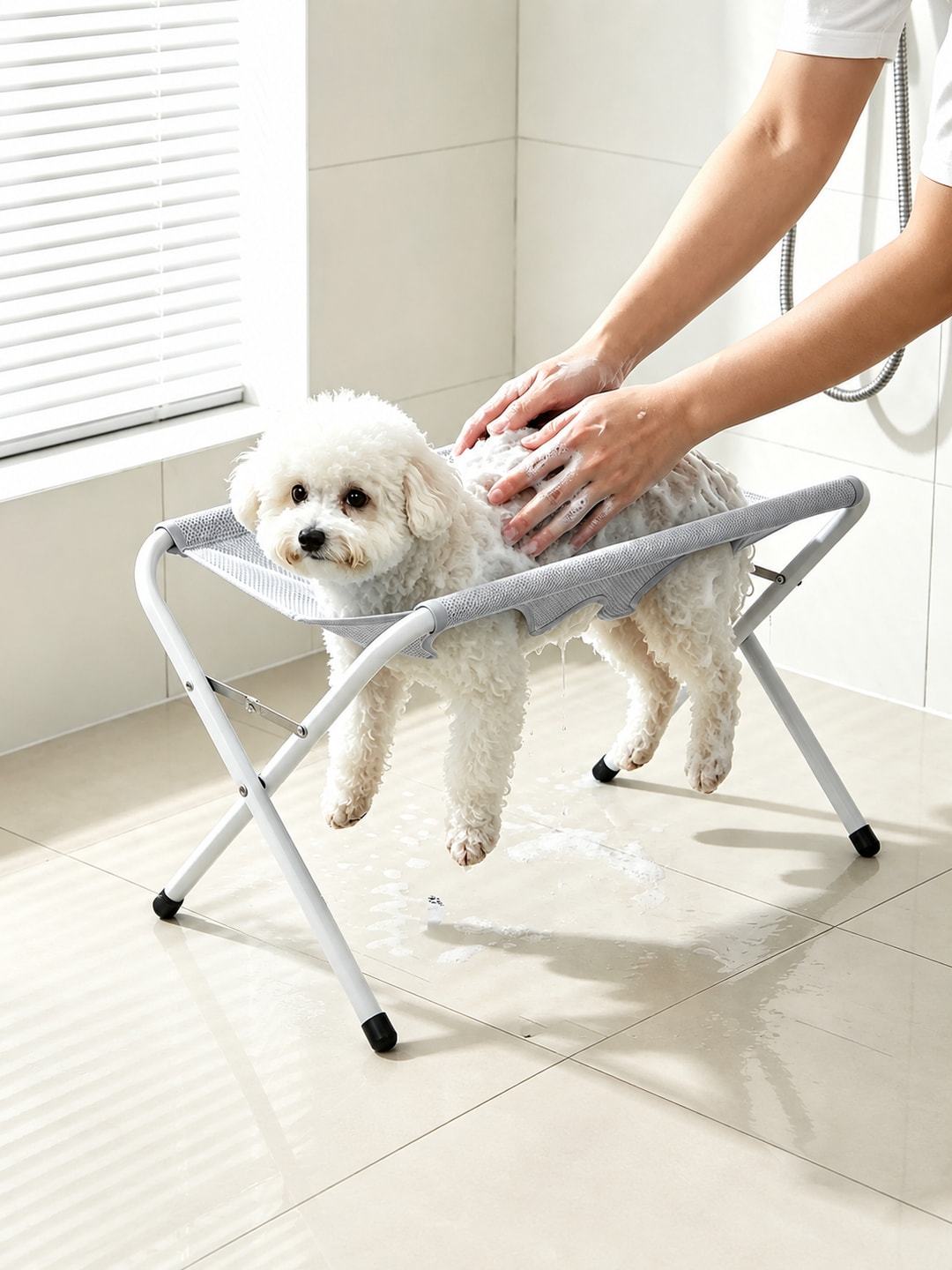 Gray pet bathing support stand shown during supervised dog washing