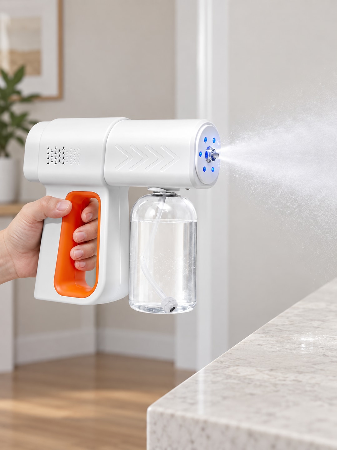 Hand holding the K6PRO electric sprayer with its clear refillable reservoir