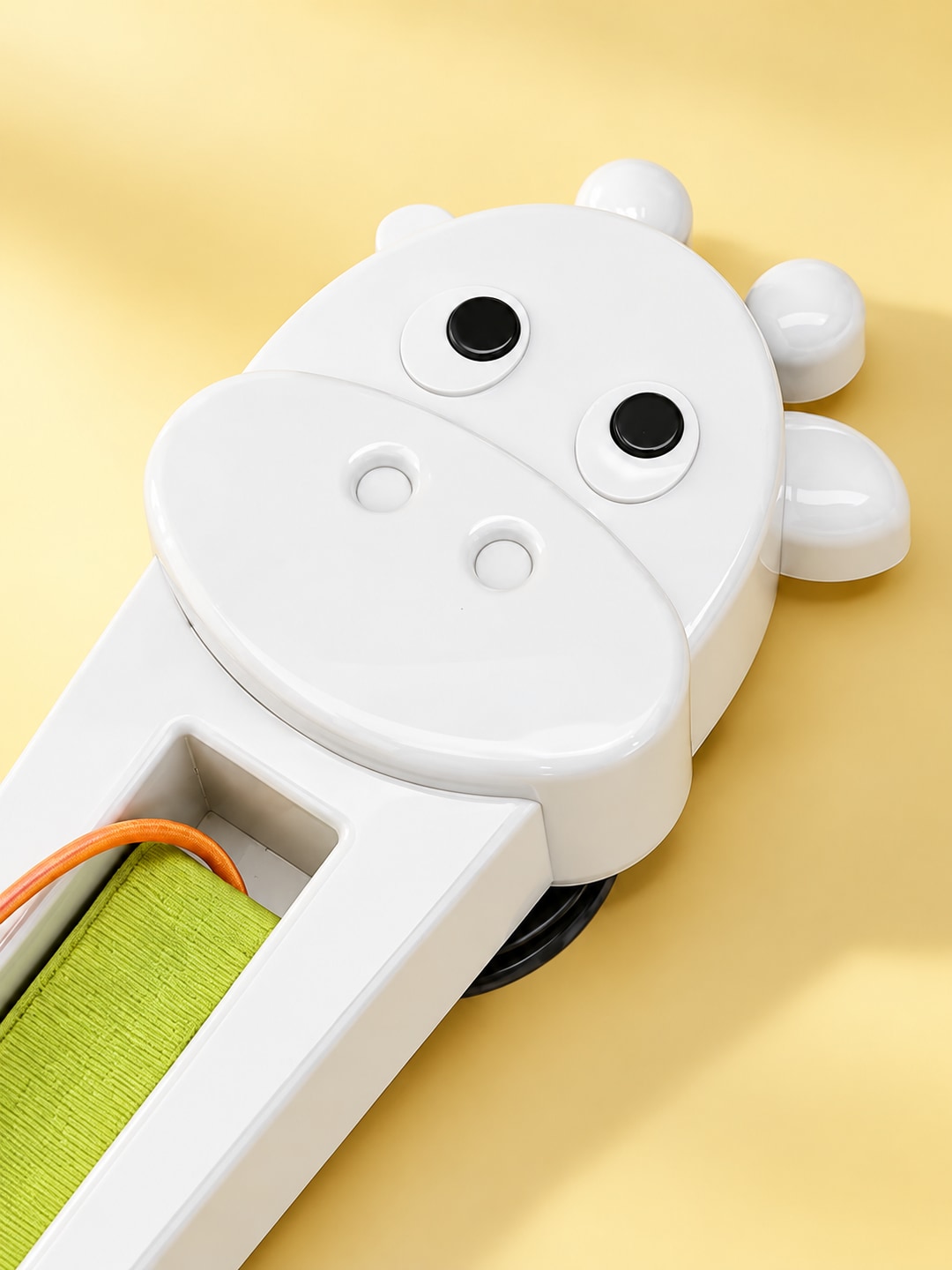 Close-up of the rounded white ABS animal-shaped toy housing and green inner channel