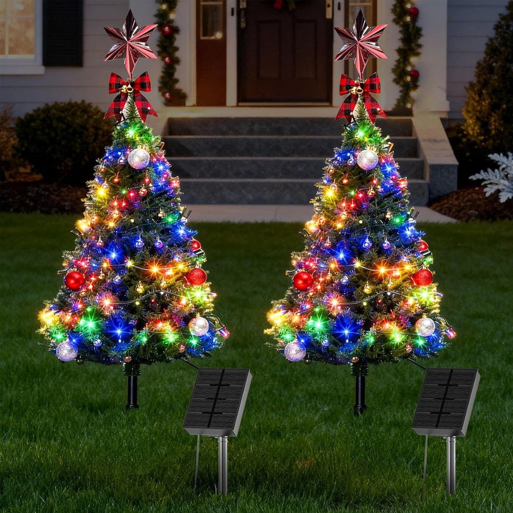 Two solar outdoor Christmas tree pathway lights with multicolor LEDs and red star toppers, product shot on plain background with solar panels