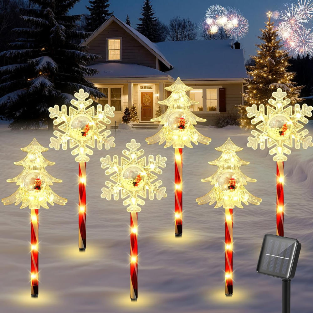 Solar Christmas pathway stake lights in snowflake, star, and tree shapes with warm white LEDs in snowy yard