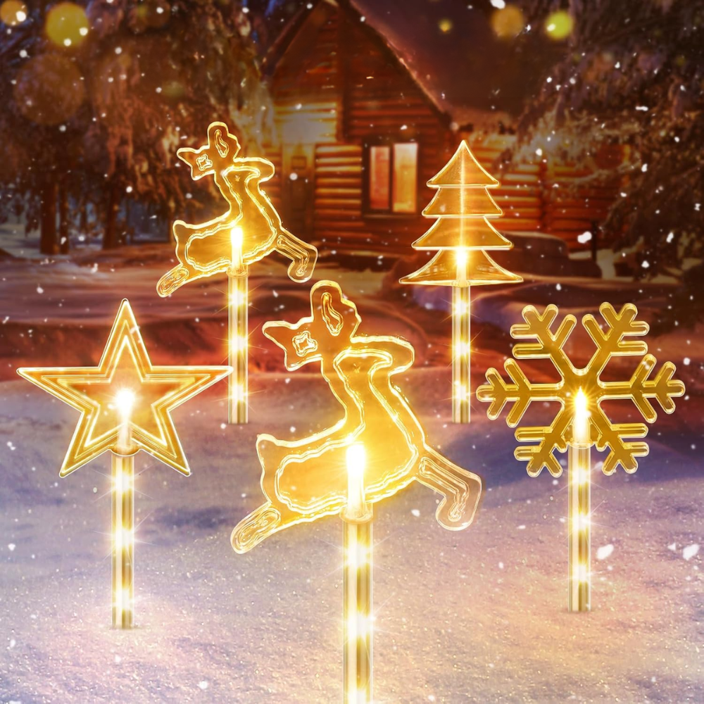 Solar Christmas pathway stake lights in reindeer, star, tree, and snowflake shapes with warm white LEDs in snowy setting