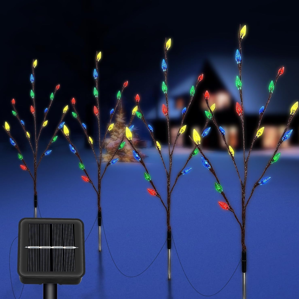 Four solar branch pathway lights with multicolor LED berry-shaped bulbs on dark branches, staked in snow, solar panel shown