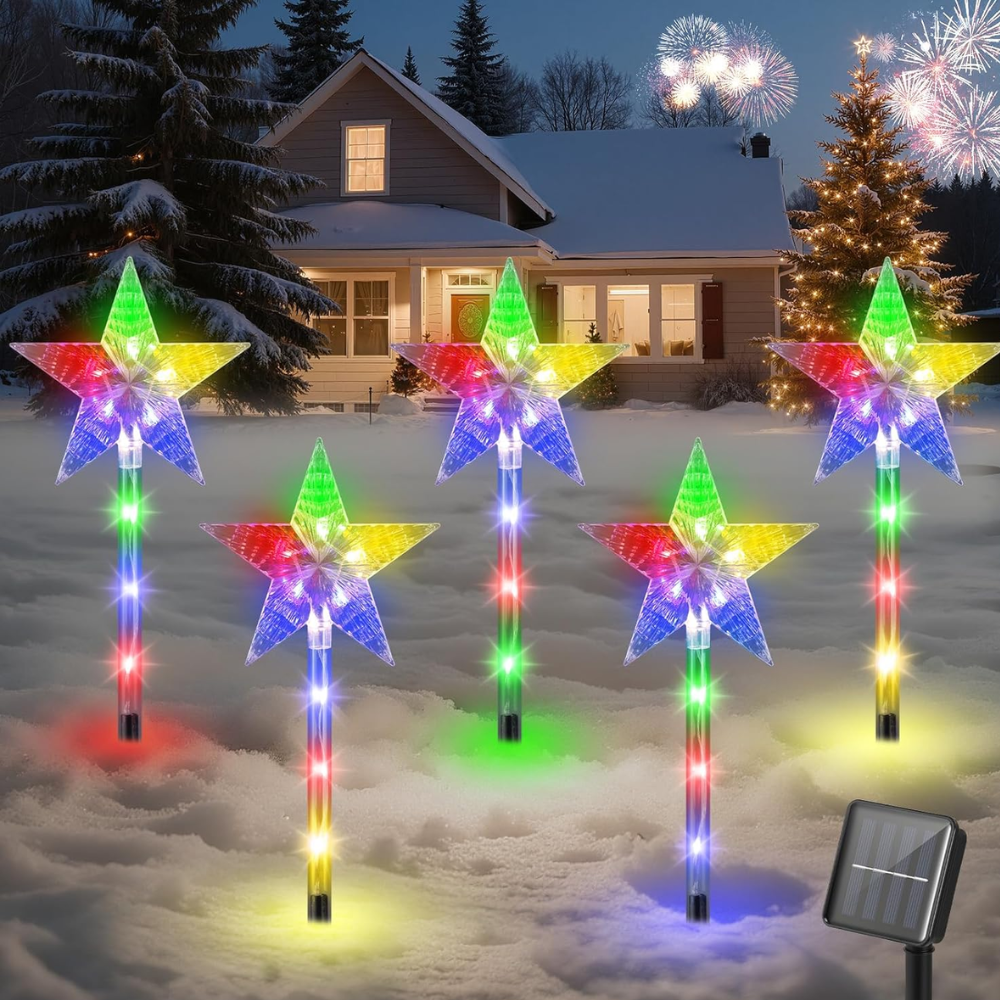 Multicolor star solar Christmas pathway stake lights in snowy yard with solar panel unit visible, white background