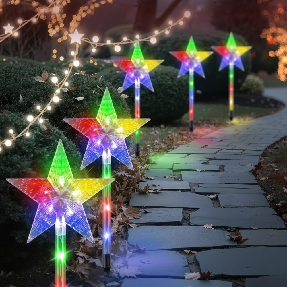 Six multicolor star solar Christmas pathway stake lights lining a garden stone path at night