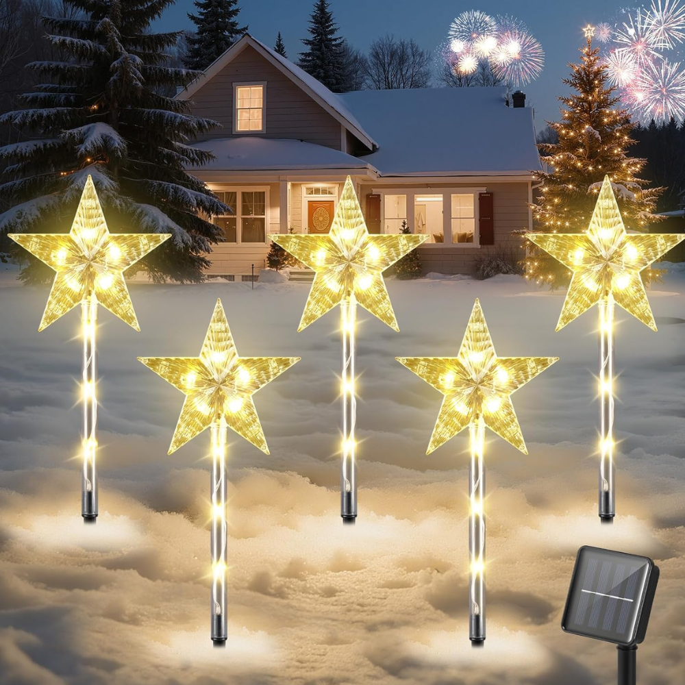 Warm white star-shaped solar Christmas pathway lights staked in snowy front yard with solar panel shown