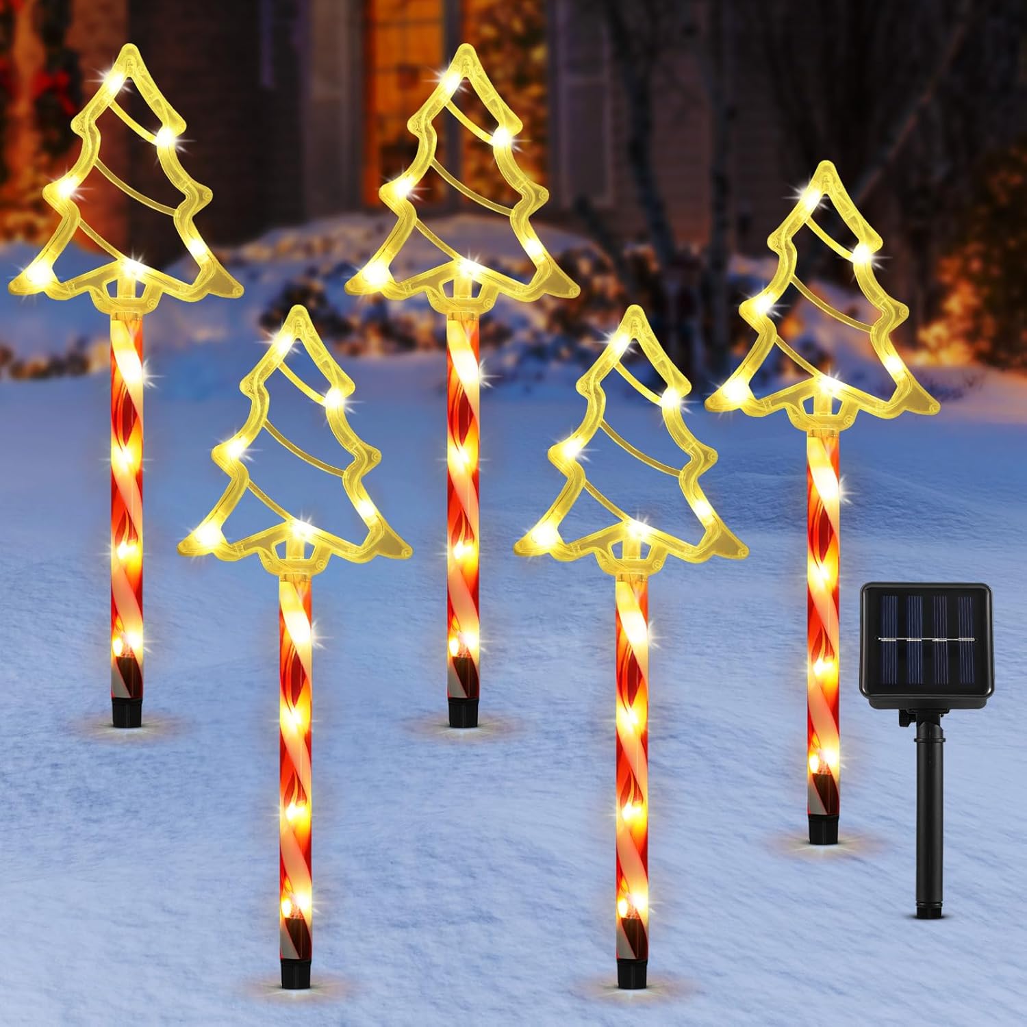 Five solar Christmas tree silhouette pathway lights with warm white LEDs and candy-cane stakes in a snowy yard, solar panel visible