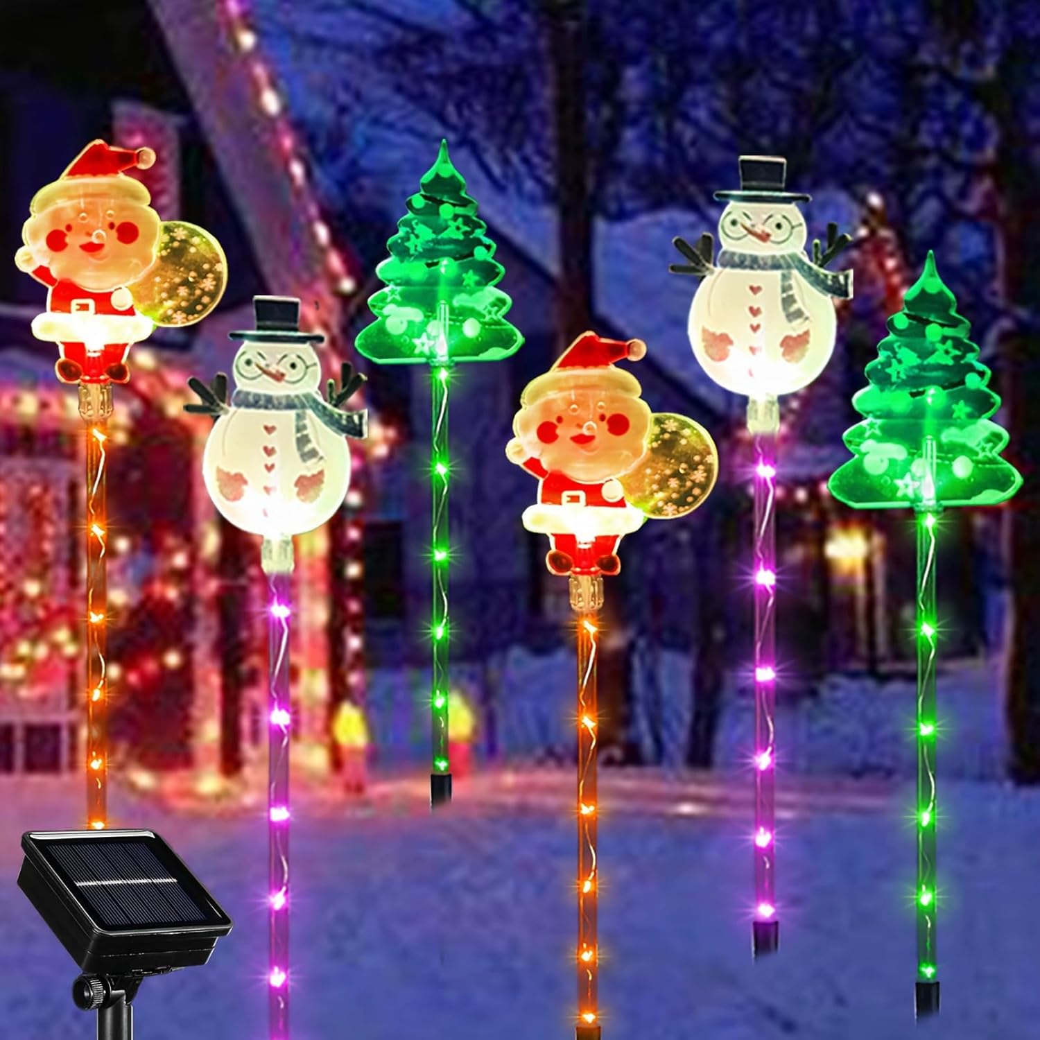 Solar Christmas pathway lights with illuminated Santa, snowman, and tree stake figures glowing with multicolor LED strands at night