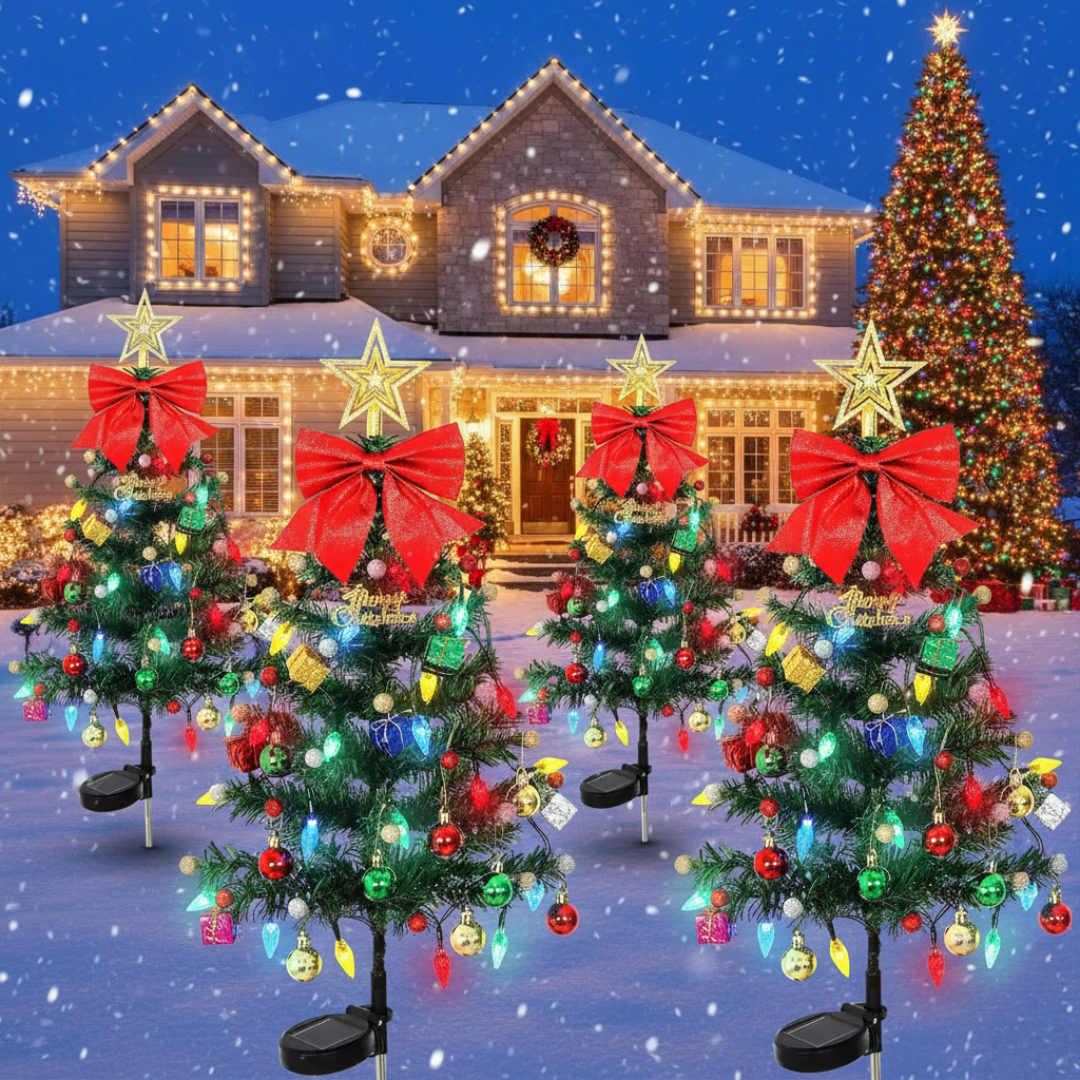 Four solar Christmas tree yard decorations with multicolor LEDs and red bow toppers lined up in a snowy front yard, showing the set-of-4 configuration with solar bases visible