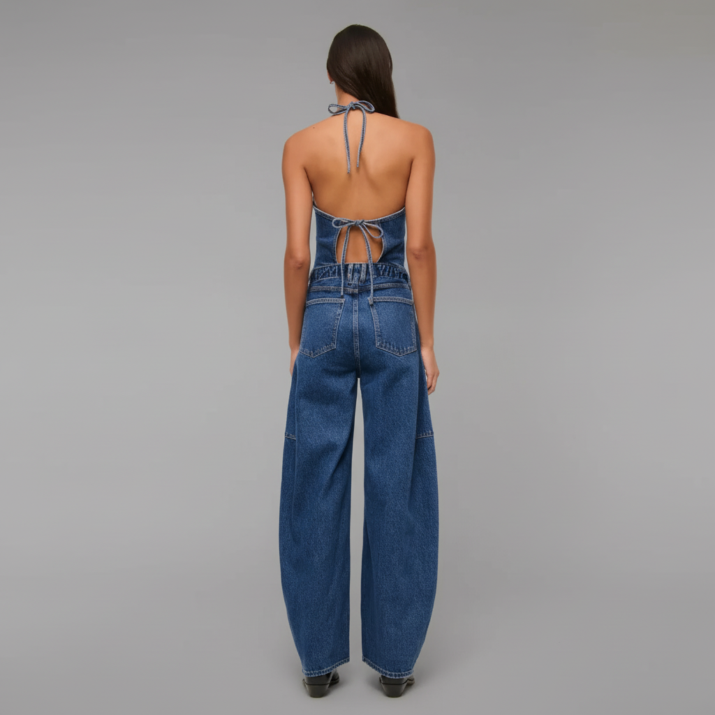 Denim Jumpsuit With Halter Tie Back For Women features a structured silhouette with a halter-style strap and adjustable tie closure at the back. The design includes a fitted bodice and straight full-length cut for a streamlined appearance.