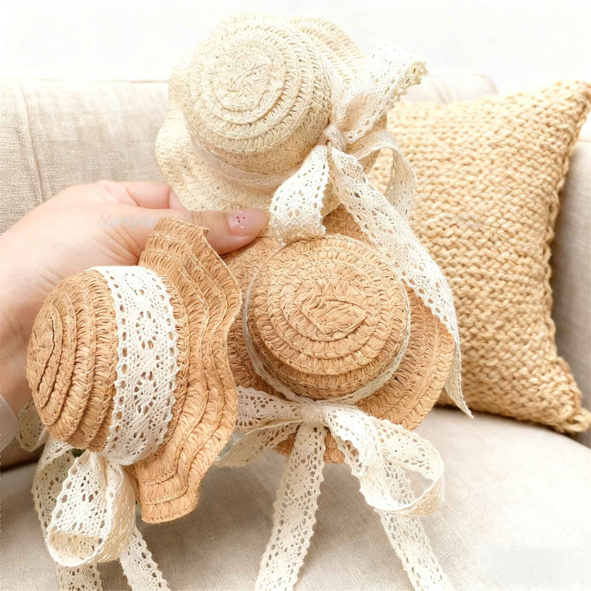 Vintage lace straw hats for BJD dolls held in hand over a boho sofa - Atelier Chantilly