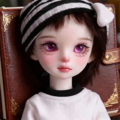 Purple glass BJD eyes for 1/4 dolls resting on a vintage leather notebook - Atelier Chantilly