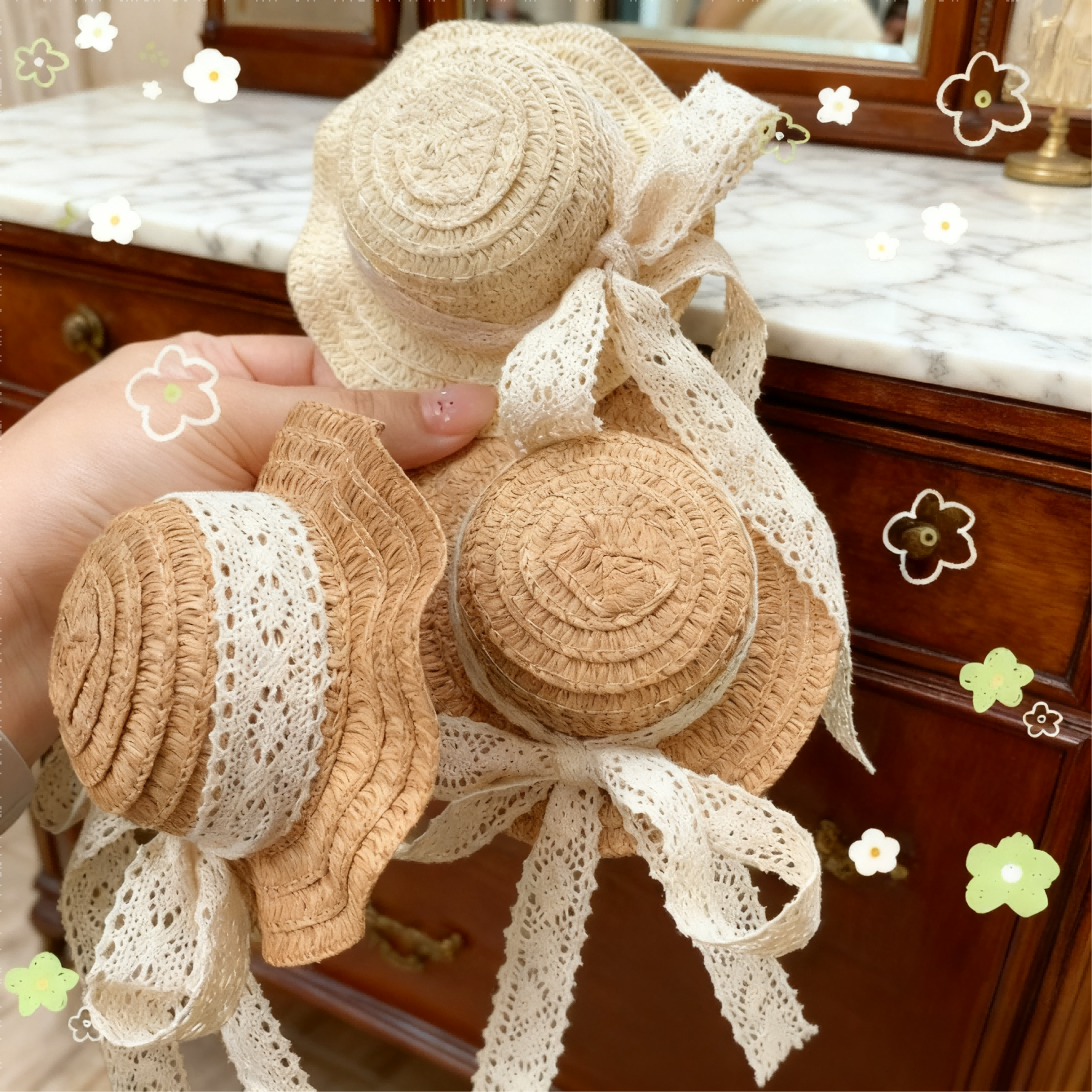 Vintage lace straw hats for BJD dolls held in hand over a marble dresser - Atelier Chantilly