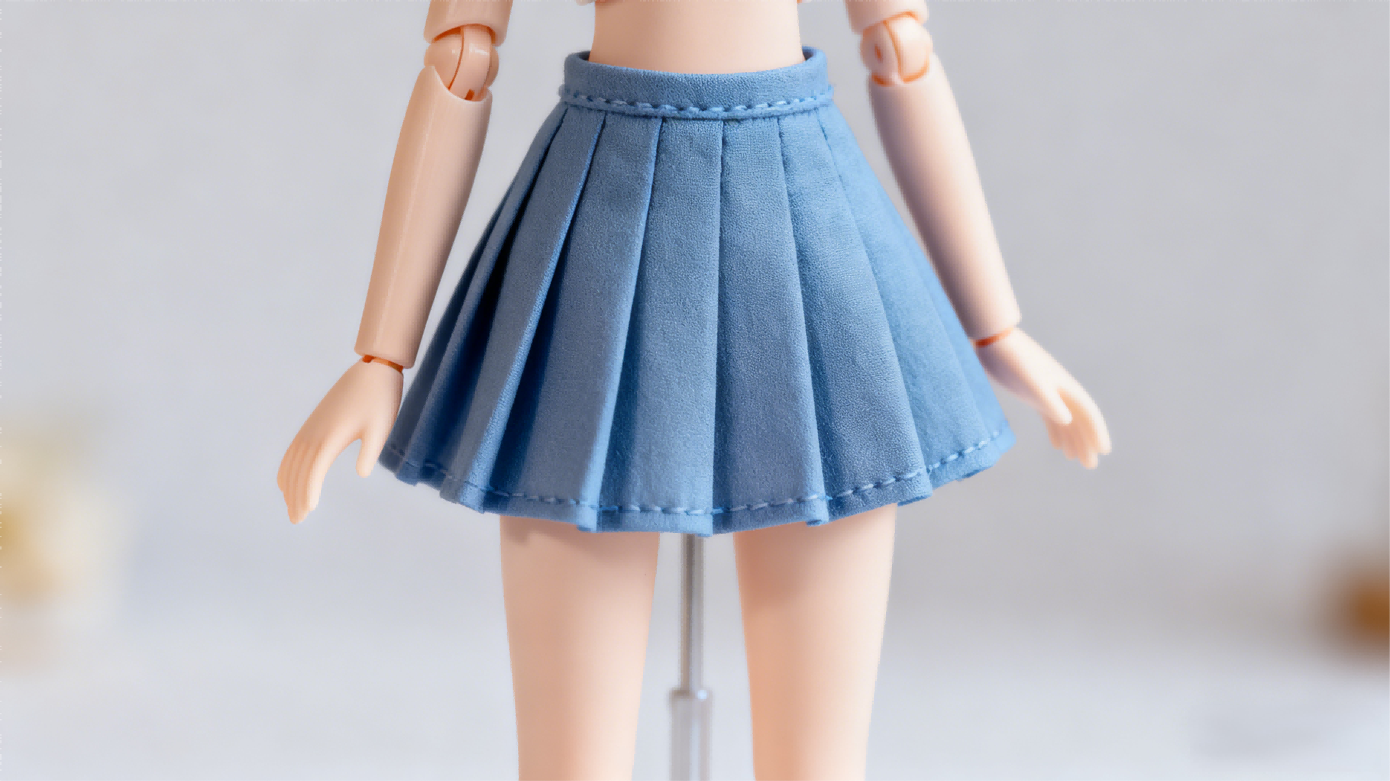 BJD doll wearing a completed simple skirt, showing folds and style
