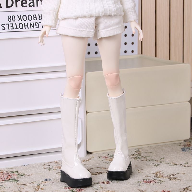 BJD doll in white knee-high boots with winter white outfit