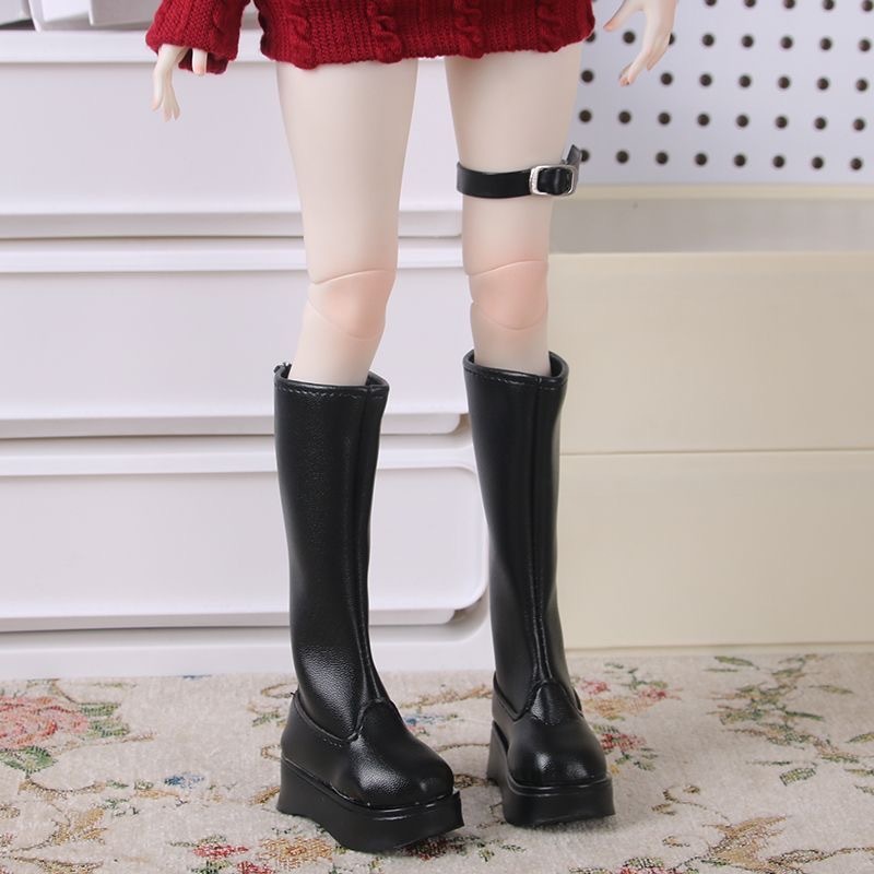 Side view of white glossy BJD doll knee-high boots
