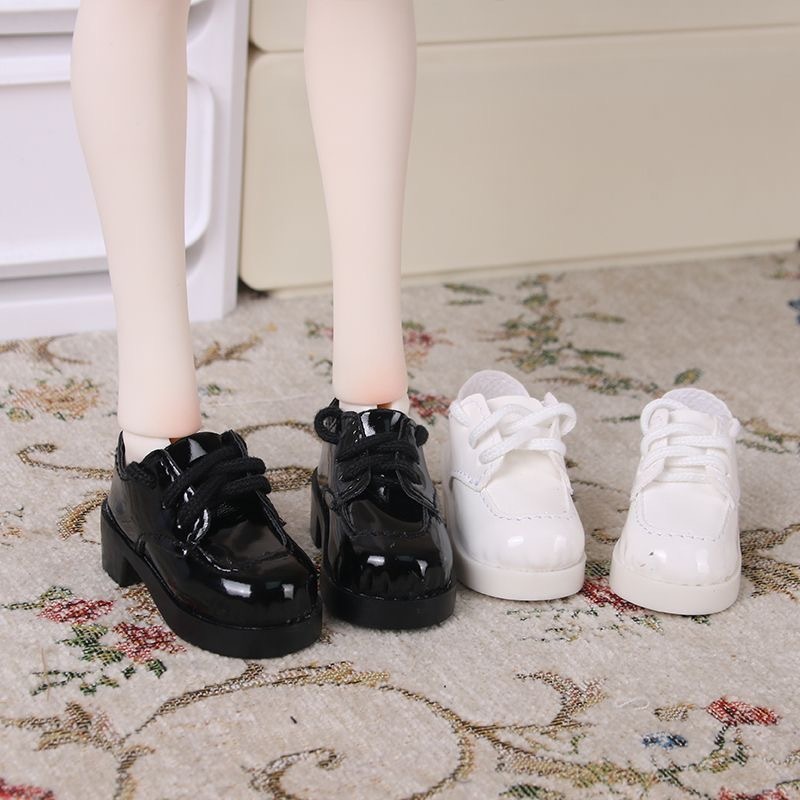 Black and white patent leather Oxford shoes for BJD dolls on display