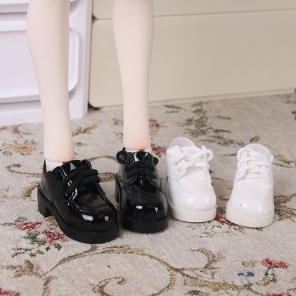 Black and white patent leather Oxford shoes for BJD dolls on display