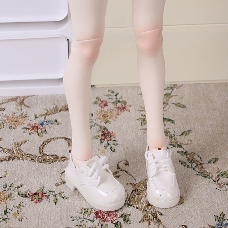 White patent leather lace-up shoes worn by BJD doll