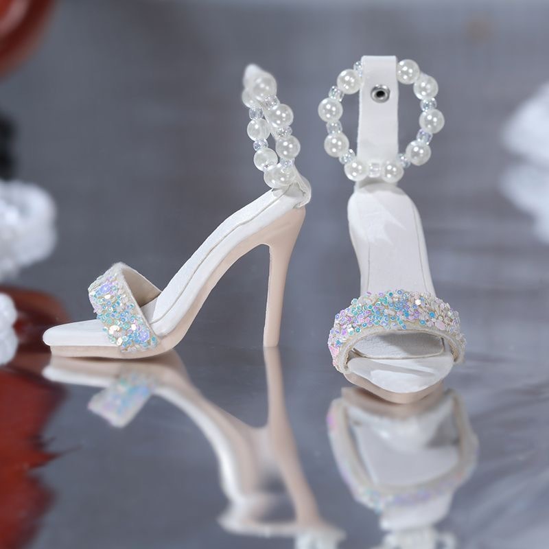 *Black sequin pearl high heels for BJD dolls on reflective surface*