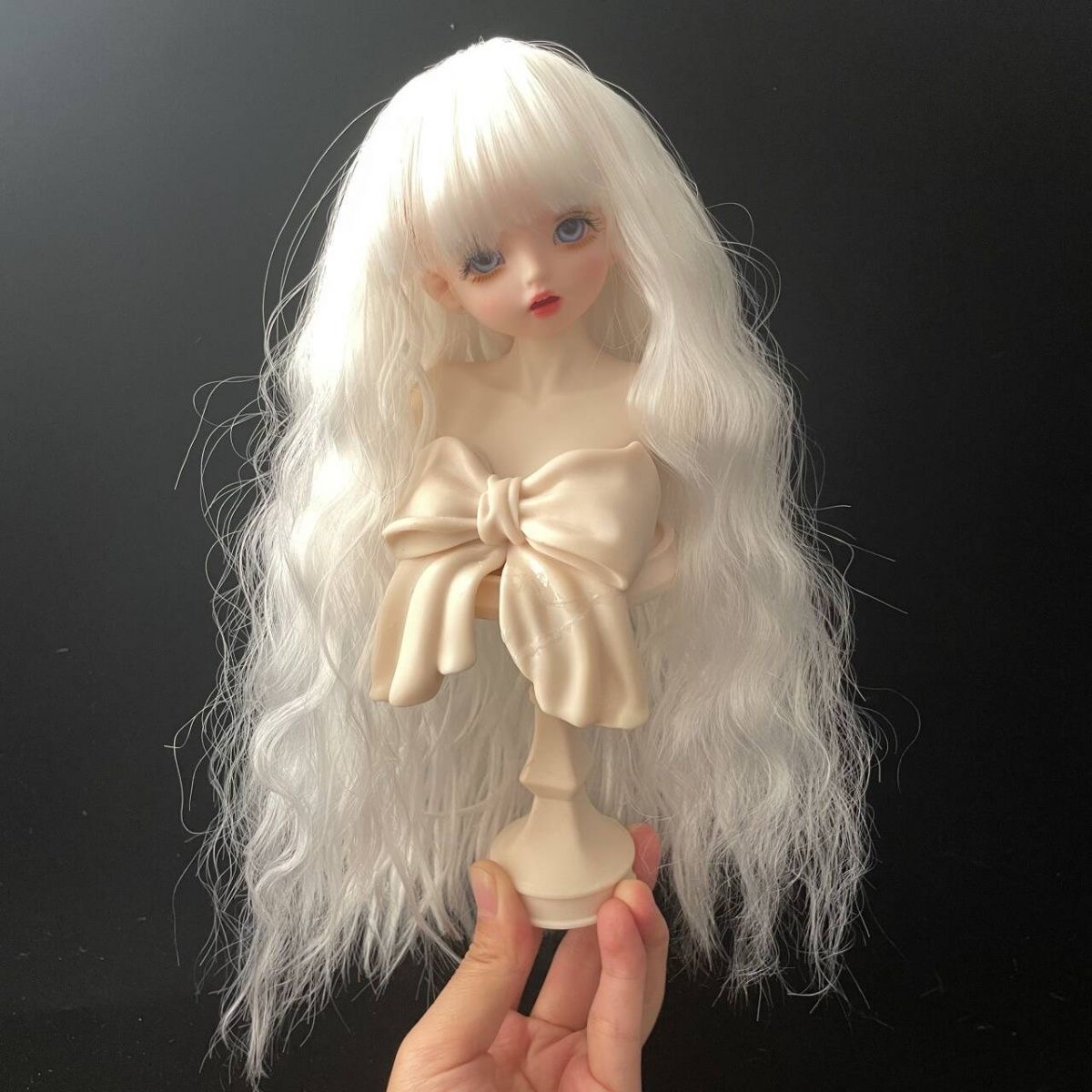 White long wavy BJD wig displayed on mannequin bust