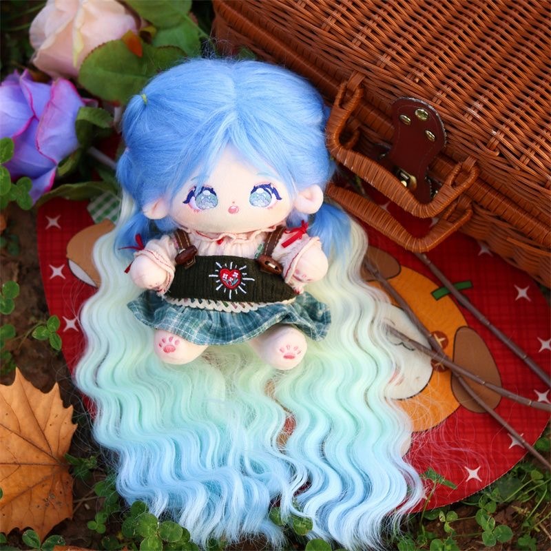 Blue-haired doll with pastel gradient curls surrounded by autumn leaves
