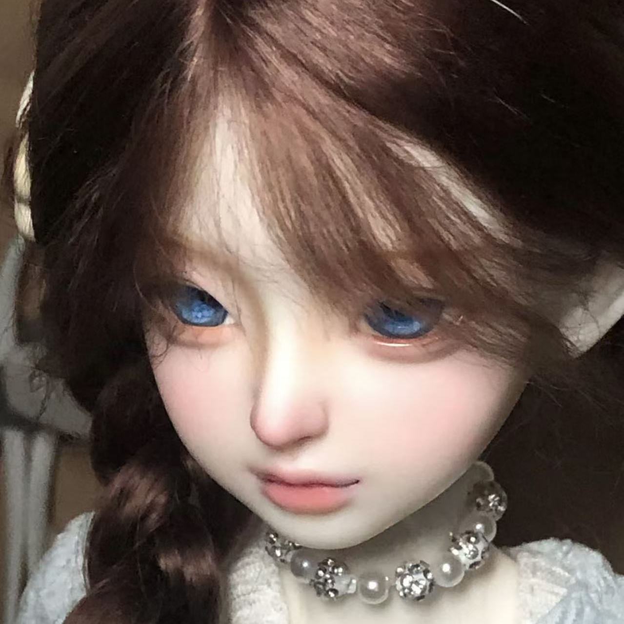 Close-up of brown braided BJD wig showing lifelike hair fiber detail