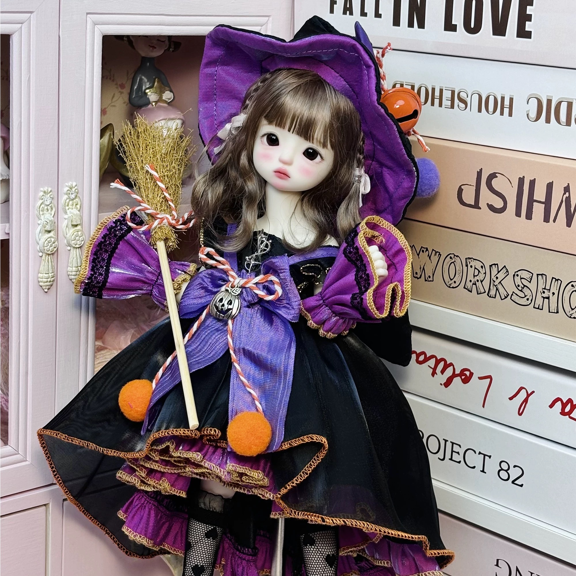1/6 BJD doll wearing purple-black witchy Lolita dress by a pink cabinet - Atelier Chantilly