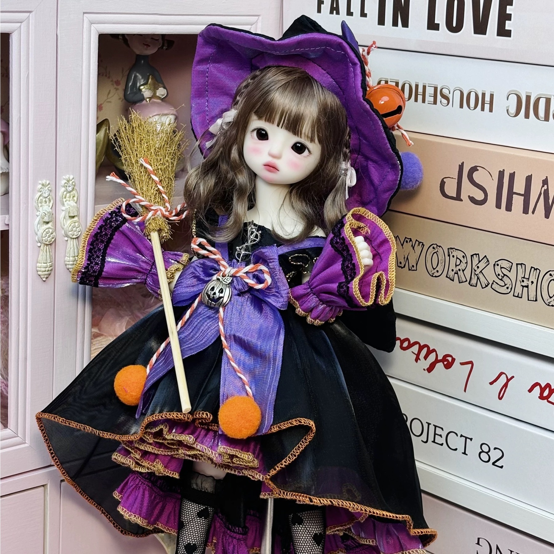 1/6 BJD doll wearing purple-black witchy Lolita dress by a pink cabinet - Atelier Chantilly