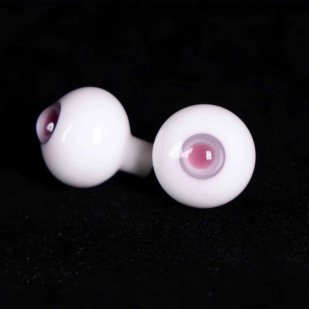 Close-up of realistic purple glass BJD eyes on a black backdrop - Atelier Chantilly