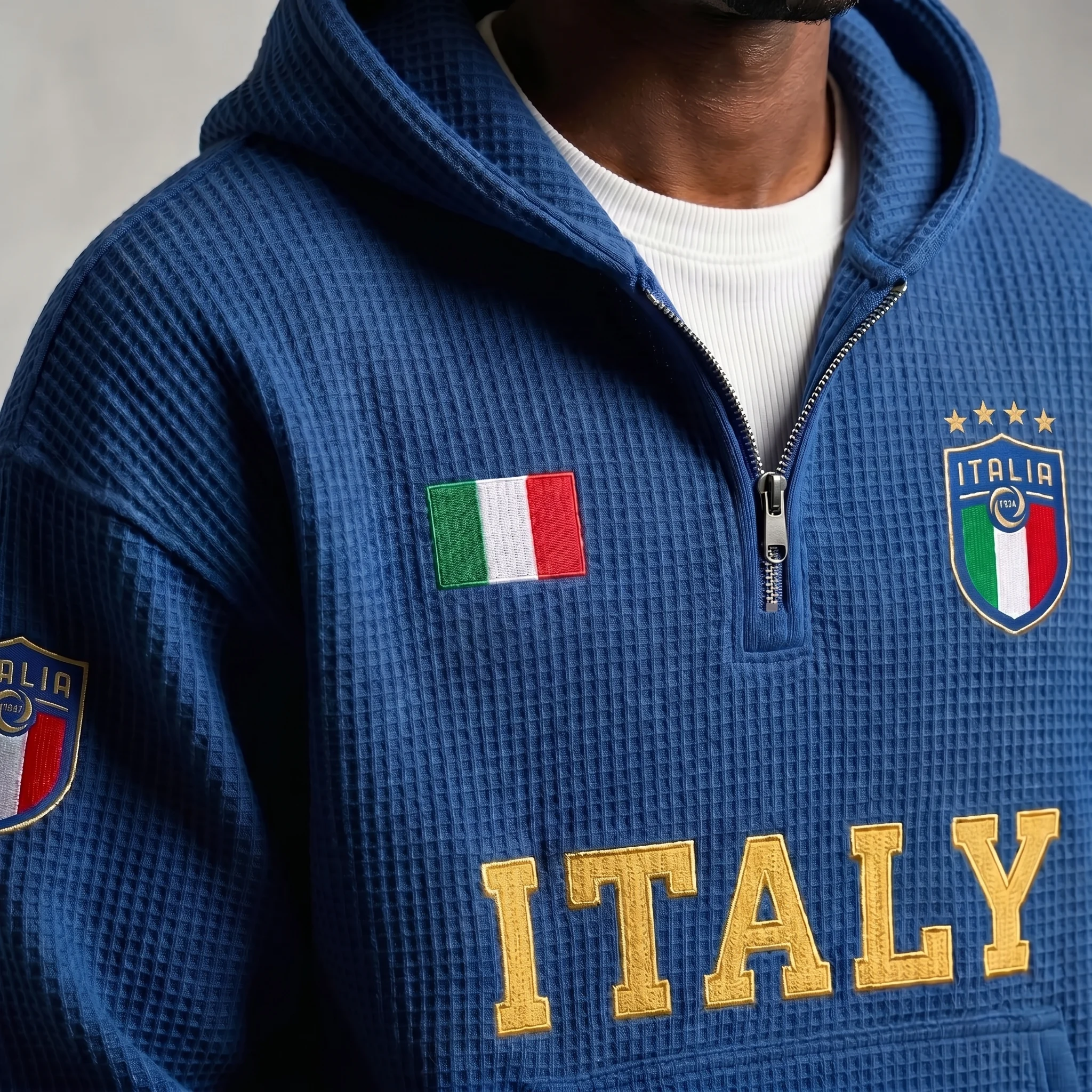 Close-up of the waffle-knit texture, quarter-zip and ITALIA crest on the Italy hoodie