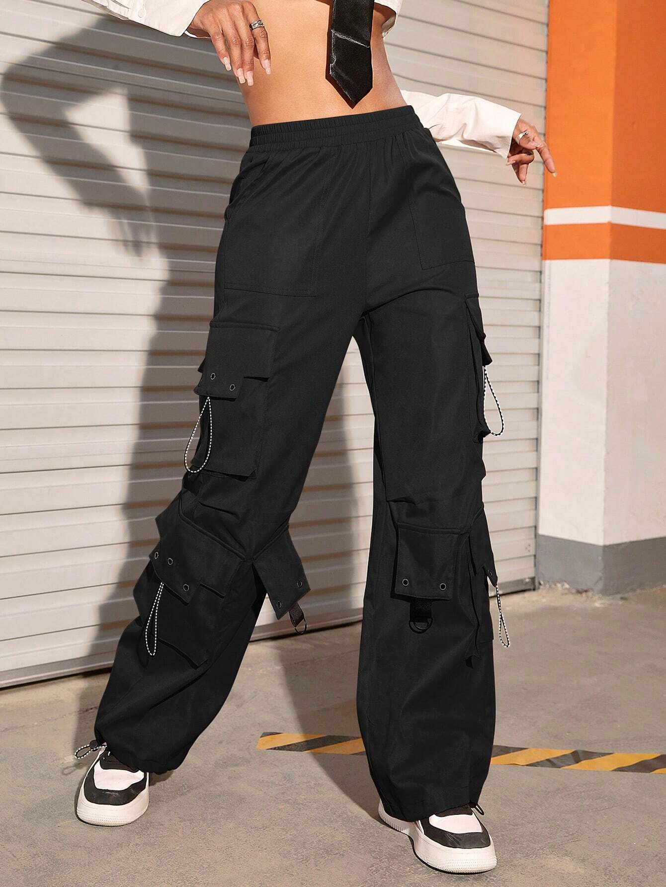 Flap Pocket Drawstring Hem Cargo Parachute Pants in Black – side profile view
