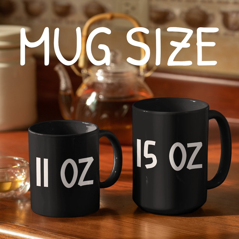 May include: Two black ceramic mugs with white text. The smaller mug is 11 oz and the larger mug is 15 oz.