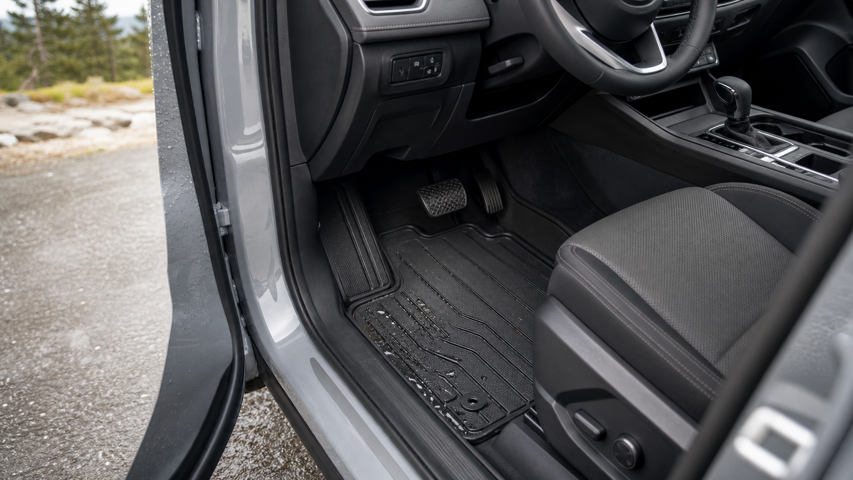 Custom-fit all-weather car floor mat secured below the pedals