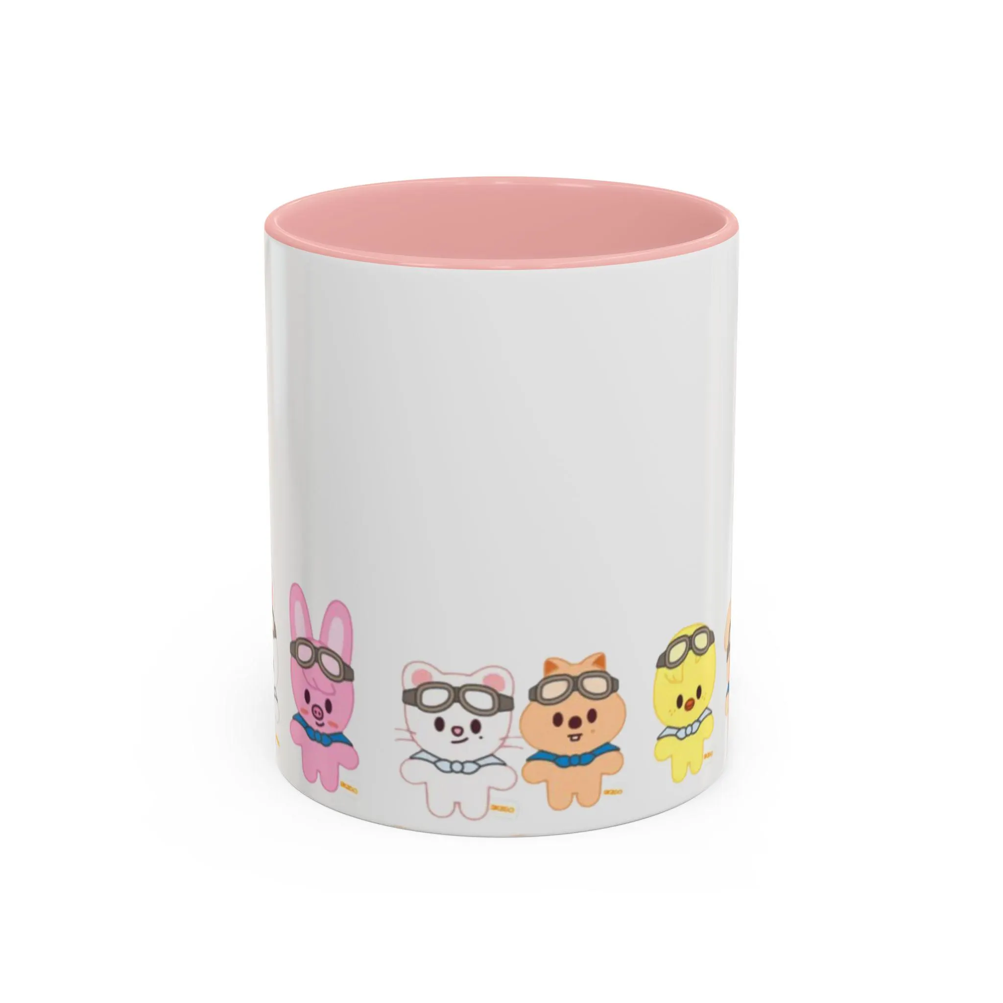 White ceramic mug featuring Skzoo characters wearing aviator goggles and scarves around the base with a pink interior