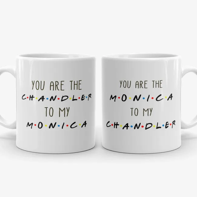 Two white ceramic mugs featuring Chandler and Monica text in television show style font